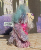 Pru is a beautiful, happy and gently colourful, one of a kind, hand dyed mohair little artist teddy bear by Barbara-Ann Bears she stands just under 5 inches/13 cm tall. Pru is made from several different mohairs that Barbara has dyed pink, lilac and blue together with a soft sky blue faux fur, velvet paw pads, hand painted eyes with eyelids, a beautifully embroidered nose and a sweet smile