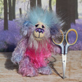 Pru is a beautiful, happy and gently colourful, one of a kind, hand dyed mohair little artist teddy bear by Barbara-Ann Bears she stands just under 5 inches/13 cm tall. Pru is made from several different mohairs that Barbara has dyed pink, lilac and blue together with a soft sky blue faux fur, velvet paw pads, hand painted eyes with eyelids, a beautifully embroidered nose and a sweet smile