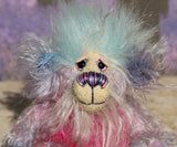 Pru has beautiful, hand painted eyes with eyelids, a splendid nose embroidered with individual threads to compliment her colouring and she has a sweet, friendly smile. Pru's face is a very long and wispy cream mohair with subtle lilac tipping, the fronts of her ears are a sparse, twirly mohair hand dyed blue and on top of her head she has a mop of very dense and soft sky blue faux fur