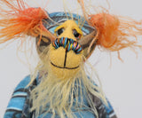 Ailsa Sunset is a beautifully coloured, sweet and slinky, one of a kind, artist bear in beautiful printed fabric and hand dyed mohair by Barbara-Ann Bears. She's a true artist bear, made from art. She stands just 8.5 inches/21 cm tall. She is made from a beautiful painting of Ailsa Craig with a hand dyed mohair face, ears and tail, hand dyed paws, hand painted eyes and a beautiful embroidered nose