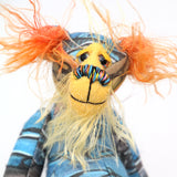 Ailsa Sunset is a beautifully coloured, sweet and slinky, one of a kind, artist bear in beautiful printed fabric and hand dyed mohair by Barbara-Ann Bears. She's a true artist bear, made from art. She stands just 8.5 inches/21 cm tall. She is made from a beautiful painting of Ailsa Craig with a hand dyed mohair face, ears and tail, hand dyed paws, hand painted eyes and a beautiful embroidered nose