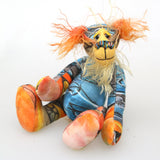 Ailsa Sunset is a beautifully coloured, sweet and slinky, one of a kind, artist bear in beautiful printed fabric and hand dyed mohair by Barbara-Ann Bears. She's a true artist bear, made from art. She stands just 8.5 inches/21 cm tall. She is made from a beautiful painting of Ailsa Craig with a hand dyed mohair face, ears and tail, hand dyed paws, hand painted eyes and a beautiful embroidered nose