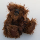Bruno Pinehandle is a wild thing, yet a very friendly wild thing, a one of a kind, artist bear by Barbara-Ann Bears in wonderful shaggy brown mohair, he stands 12 inches/30 cm tall. He is made from a long dark brown mohair, with a longer dark brown mohair with black tipping and he has dark brown wool felt paw pads. He has beautiful hand painted glass eyes with hand coloured eyelids, a splendid nose embroidered in black cotton and a broad and cheerful smile
