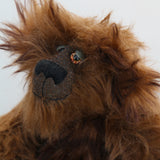 Bruno Pinehandle is a wild thing, yet a very friendly wild thing, a one of a kind, artist bear by Barbara-Ann Bears in wonderful shaggy brown mohair, he stands 12 inches/30 cm tall. He is made from a long dark brown mohair, with a longer dark brown mohair with black tipping and he has dark brown wool felt paw pads. He has beautiful hand painted glass eyes with hand coloured eyelids, a splendid nose embroidered in black cotton and a broad and cheerful smile