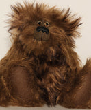 Bruno Pinehandle is a wild thing, yet a very friendly wild thing, a one of a kind, artist bear by Barbara-Ann Bears in wonderful shaggy brown mohair, he stands 12 inches/30 cm tall. He is made from a long dark brown mohair, with a longer dark brown mohair with black tipping and he has dark brown wool felt paw pads. He has beautiful hand painted glass eyes with hand coloured eyelids, a splendid nose embroidered in black cotton and a broad and cheerful smile