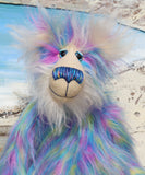 Celeste a huggable and colourful one of a kind artist bear in stunning faux fur and gorgeous fluffy mohair by Barbara-Ann Bears, she stands 18 inches/46 cm tall. Se is made from a long faux fur in blue, pink and yellow with, long fluffy white mohair, large hand painted eyes with eyelids, a splendid nose and a huge, beaming smile.