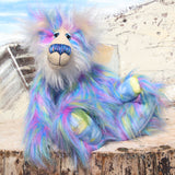 Celeste a huggable and colourful one of a kind artist bear in stunning faux fur and gorgeous fluffy mohair by Barbara-Ann Bears, she stands 18 inches/46 cm tall. Se is made from a long faux fur in blue, pink and yellow with, long fluffy white mohair, large hand painted eyes with eyelids, a splendid nose and a huge, beaming smile.