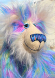 Celeste a huggable and colourful one of a kind artist bear in stunning faux fur and gorgeous fluffy mohair by Barbara-Ann Bears, she stands 18 inches/46 cm tall. Se is made from a long faux fur in blue, pink and yellow with, long fluffy white mohair, large hand painted eyes with eyelids, a splendid nose and a huge, beaming smile.