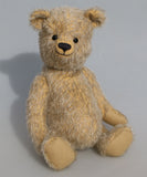 Christopher is a sweet and cuddly, traditional artist teddy bear made in splendid German mohair by Barbara Ann Bears, he stands 14 inches/ 36cm tall and is 11 inches/28cm sitting. Christopher is made from a silvery grey straight pile German mohair, with beige wool felt paw pads vintage boot buttons for eyes and a sweet smile