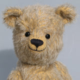 Christopher is a sweet and cuddly, traditional artist teddy bear made in splendid German mohair by Barbara Ann Bears, he stands 14 inches/ 36cm tall and is 11 inches/28cm sitting. Christopher is made from a silvery grey straight pile German mohair, with beige wool felt paw pads vintage boot buttons for eyes and a sweet smile