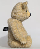 Christopher is a sweet and cuddly, traditional artist teddy bear made in splendid German mohair by Barbara Ann Bears, he stands 14 inches/ 36cm tall and is 11 inches/28cm sitting. Christopher is made from a silvery grey straight pile German mohair, with beige wool felt paw pads vintage boot buttons for eyes and a sweet smile