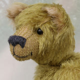 Dimpty Dimwit is sweet and happy bear, a veteran mohair artist bear from Barbara-Ann Bears, he stands 14 inches/36 cm tall. Dimpty Dimwit is made in khaki coloured straight mohair, with a beige mohair tummy and a proper belly button. He has pale beige wool felt paw pads, vintage boot button eyes and a charcoal wool nose