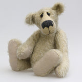 Howard is a charming and very friendly, one of a kind mohair artist bear by Barbara-Ann Bears, he stands 13.5 inches/41cm tall and is 10inches/25cm sitting. Howard is made from a medium length, sparse silvery grey mohair, with grey wool felt paw pads, hand painted glass eyes with hand coloured eyelids and a splendid nose embroidered from charcoal coloured wool