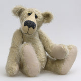 Howard is a charming and very friendly, one of a kind mohair artist bear by Barbara-Ann Bears, he stands 13.5 inches/41cm tall and is 10inches/25cm sitting. Howard is made from a medium length, sparse silvery grey mohair, with grey wool felt paw pads, hand painted glass eyes with hand coloured eyelids and a splendid nose embroidered from charcoal coloured wool