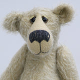 Howard is a charming and very friendly, one of a kind mohair artist bear by Barbara-Ann Bears, he stands 13.5 inches/41cm tall and is 10inches/25cm sitting. Howard is made from a medium length, sparse silvery grey mohair, with grey wool felt paw pads, hand painted glass eyes with hand coloured eyelids and a splendid nose embroidered from charcoal coloured wool