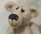 Howard is a charming and very friendly, one of a kind mohair artist bear by Barbara-Ann Bears, he stands 13.5 inches/41cm tall and is 10inches/25cm sitting. Howard is made from a medium length, sparse silvery grey mohair, with grey wool felt paw pads, hand painted glass eyes with hand coloured eyelids and a splendid nose embroidered from charcoal coloured wool