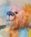 Ernie is a very happy and colourful little teddy bear, a one of a kind, mohair artist bear by Barbara-Ann Bears, he stands just under 6 inches/15 cm tall.  Ernie is made from many different colourful mohairs, hand painted eyes with hand coloured eyelids, a splendid nose embroidered from individual threads and he has a sweet, friendly smile.