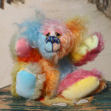 Ernie is a very happy and colourful little teddy bear, a one of a kind, mohair artist bear by Barbara-Ann Bears, he stands just under 6 inches/15 cm tall.  Ernie is made from many different colourful mohairs, hand painted eyes with hand coloured eyelids, a splendid nose embroidered from individual threads and he has a sweet, friendly smile.