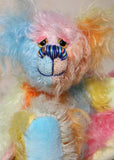 Ernie is a very happy and colourful little teddy bear, a one of a kind, mohair artist bear by Barbara-Ann Bears, he stands just under 6 inches/15 cm tall.  Ernie is made from many different colourful mohairs, hand painted eyes with hand coloured eyelids, a splendid nose embroidered from individual threads and he has a sweet, friendly smile.
