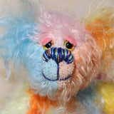 Ernie is a very happy and colourful little teddy bear, a one of a kind, mohair artist bear by Barbara-Ann Bears, he stands just under 6 inches/15 cm tall.  Ernie is made from many different colourful mohairs, hand painted eyes with hand coloured eyelids, a splendid nose embroidered from individual threads and he has a sweet, friendly smile.