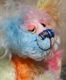 Ernie is a very happy and colourful little teddy bear, a one of a kind, mohair artist bear by Barbara-Ann Bears, he stands just under 6 inches/15 cm tall.  Ernie is made from many different colourful mohairs, hand painted eyes with hand coloured eyelids, a splendid nose embroidered from individual threads and he has a sweet, friendly smile.