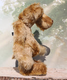 Fingal is quite a large and comical, one of a kind, artist bear by Barbara-Ann Bears in wonderful batik German mohair, he stands 20.5 inches/ 52cm tall and is 15 inches/38 cm sitting. Fingal is made from batik mohair in bands and patches of coffee and beige with greyish beige German wool felt paw pads, beautiful hand painted glass eyes with hand coloured eyelids, an impressive and wonderfully embroidered nose and an engaging smile.