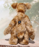 Fingal is quite a large and comical, one of a kind, artist bear by Barbara-Ann Bears in wonderful batik German mohair, he stands 20.5 inches/ 52cm tall and is 15 inches/38 cm sitting. Fingal is made from batik mohair in bands and patches of coffee and beige with greyish beige German wool felt paw pads, beautiful hand painted glass eyes with hand coloured eyelids, an impressive and wonderfully embroidered nose and an engaging smile.