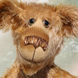 Fingal is quite a large and comical, one of a kind, artist bear by Barbara-Ann Bears in wonderful batik German mohair, he stands 20.5 inches/ 52cm tall and is 15 inches/38 cm sitting. Fingal is made from batik mohair in bands and patches of coffee and beige with greyish beige German wool felt paw pads, beautiful hand painted glass eyes with hand coloured eyelids, an impressive and wonderfully embroidered nose and an engaging smile.
