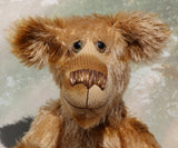 Fingal is quite a large and comical, one of a kind, artist bear by Barbara-Ann Bears in wonderful batik German mohair, he stands 20.5 inches/ 52cm tall and is 15 inches/38 cm sitting. Fingal is made from batik mohair in bands and patches of coffee and beige with greyish beige German wool felt paw pads, beautiful hand painted glass eyes with hand coloured eyelids, an impressive and wonderfully embroidered nose and an engaging smile.