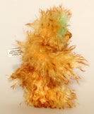 Green Eared Banana Stalker is a little, endearingly sweet and joyful, one of a kind, artist bear by Barbara-Ann Bears in wonderfully fluffy mohair, he stands 6.5 inches/17 cm tall. He is mostly made from a long golden mohair with brown tipping, with hand dyed green mohair ears, and beige wool felt paw pads. He has hand painted glass eyes with hand coloured eyelids, a wonderfully embroidered nose and a broad and cheerful smile.