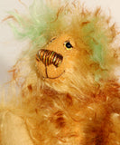 Green Eared Banana Stalker is a little, endearingly sweet and joyful, one of a kind, artist bear by Barbara-Ann Bears in wonderfully fluffy mohair, he stands 6.5 inches/17 cm tall. He is mostly made from a long golden mohair with brown tipping, with hand dyed green mohair ears, and beige wool felt paw pads. He has hand painted glass eyes with hand coloured eyelids, a wonderfully embroidered nose and a broad and cheerful smile.