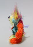 Harry Tickle is a very happy and colourful little one of a kind, hand dyed mohair and faux fur artist bear by Barbara-Ann Bears, he stands 6.5 inches/16 cm tall. Harry Tickle is made from hand dyed mohair, with long plumes of faux fur on his head, hand painted eyes, a multicoloured nose and a beaming smile a happy bear!