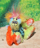 Harry Tickle is a very happy and colourful little one of a kind, hand dyed mohair and faux fur artist bear by Barbara-Ann Bears, he stands 6.5 inches/16 cm tall. Harry Tickle is made from hand dyed mohair, with long plumes of faux fur on his head, hand painted eyes, a multicoloured nose and a beaming smile a happy bear!