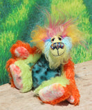 Harry Tickle is a very happy and colourful little one of a kind, hand dyed mohair and faux fur artist bear by Barbara-Ann Bears, he stands 6.5 inches/16 cm tall. Harry Tickle is made from hand dyed mohair, with long plumes of faux fur on his head, hand painted eyes, a multicoloured nose and a beaming smile a happy bear!