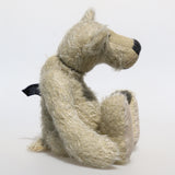 Howard is a charming and very friendly, one of a kind mohair artist bear by Barbara-Ann Bears, he stands 13.5 inches/41cm  tall and is 10inches/25cm sitting.  Howard is made from a medium length, sparse silvery grey mohair, with grey wool felt paw pads, hand painted glass eyes with hand coloured eyelids and a splendid nose embroidered from charcoal coloured wool