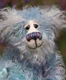 Hyssop is a gentle, happy teddy bear, a beautifully blue one of a kind, hand dyed mohair artist bear by Barbara-Ann Bears, he stands 9 inches/23 cm tall  Hyssop is mainly made from a fairly long, sparse hand dyed sky blue, coupled with a long fluffy white mohair with blue tipping and hand-dyed velvet paw pads.   Hyssop has beautiful hand painted eyes with eyelids, a nose embroidered from individual threads to complement his colouring and he has a huge, friendly smile.
