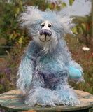Hyssop is a gentle, happy teddy bear, a beautifully blue one of a kind, hand dyed mohair artist bear by Barbara-Ann Bears, he stands 9 inches/23 cm tall  Hyssop is mainly made from a fairly long, sparse hand dyed sky blue, coupled with a long fluffy white mohair with blue tipping and hand-dyed velvet paw pads.   Hyssop has beautiful hand painted eyes with eyelids, a nose embroidered from individual threads to complement his colouring and he has a huge, friendly smile.