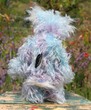 Hyssop is a gentle, happy teddy bear, a beautifully blue one of a kind, hand dyed mohair artist bear by Barbara-Ann Bears, he stands 9 inches/23 cm tall  Hyssop is mainly made from a fairly long, sparse hand dyed sky blue, coupled with a long fluffy white mohair with blue tipping and hand-dyed velvet paw pads.   Hyssop has beautiful hand painted eyes with eyelids, a nose embroidered from individual threads to complement his colouring and he has a huge, friendly smile.