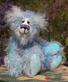 Hyssop is a gentle, happy teddy bear, a beautifully blue one of a kind, hand dyed mohair artist bear by Barbara-Ann Bears, he stands 9 inches/23 cm tall  Hyssop is mainly made from a fairly long, sparse hand dyed sky blue, coupled with a long fluffy white mohair with blue tipping and hand-dyed velvet paw pads.   Hyssop has beautiful hand painted eyes with eyelids, a nose embroidered from individual threads to complement his colouring and he has a huge, friendly smile.