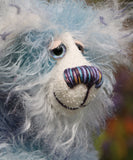 Hyssop is a gentle, happy teddy bear, a beautifully blue one of a kind, hand dyed mohair artist bear by Barbara-Ann Bears, he stands 9 inches/23 cm tall  Hyssop is mainly made from a fairly long, sparse hand dyed sky blue, coupled with a long fluffy white mohair with blue tipping and hand-dyed velvet paw pads.   Hyssop has beautiful hand painted eyes with eyelids, a nose embroidered from individual threads to complement his colouring and he has a huge, friendly smile.