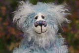 Hyssop is a gentle, happy teddy bear, a beautifully blue one of a kind, hand dyed mohair artist bear by Barbara-Ann Bears, he stands 9 inches/23 cm tall Hyssop is mainly made from a fairly long, sparse hand dyed sky blue, coupled with a long fluffy white mohair with blue tipping and hand-dyed velvet paw pads. Hyssop has beautiful hand painted eyes with eyelids, a nose embroidered from individual threads to complement his colouring and he has a huge, friendly smile.