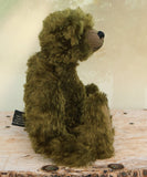 Kingsley Greenacre is a very sweet and cuddly one of a kind traditional artist teddy bear by Barbara Ann Bears in bottle green mohair he is 13 inches/33cm tall.  Kingsley Greenacre is made from a beautiful, distressed bottle green German mohair and he has German wool-felt paw pads that coordinate very well with his mohair. Kingsley has boot buttons for eyes, just like the really old teddy bears. He has a carefully embroidered nose and a sweet smile.