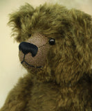 Kingsley Greenacre is a very sweet and cuddly one of a kind traditional artist teddy bear by Barbara Ann Bears in bottle green mohair he is 13 inches/33cm tall.  Kingsley Greenacre is made from a beautiful, distressed bottle green German mohair and he has German wool-felt paw pads that coordinate very well with his mohair. Kingsley has boot buttons for eyes, just like the really old teddy bears. He has a carefully embroidered nose and a sweet smile.
