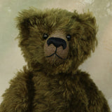 Kingsley Greenacre is a very sweet and cuddly one of a kind traditional artist teddy bear by Barbara Ann Bears in bottle green mohair he is 13 inches/33cm tall.  Kingsley Greenacre is made from a beautiful, distressed bottle green German mohair and he has German wool-felt paw pads that coordinate very well with his mohair. Kingsley has boot buttons for eyes, just like the really old teddy bears. He has a carefully embroidered nose and a sweet smile.