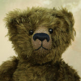Kingsley Greenacre is a very sweet and cuddly one of a kind traditional artist teddy bear by Barbara Ann Bears in bottle green mohair he is 13 inches/33cm tall.  Kingsley Greenacre is made from a beautiful, distressed bottle green German mohair and he has German wool-felt paw pads that coordinate very well with his mohair. Kingsley has boot buttons for eyes, just like the really old teddy bears. He has a carefully embroidered nose and a sweet smile.