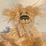 Close-up of a plush teddy bear made from long textured mohair