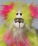 Leonardo is a flamboyant, fun-loving and comical, one of a kind, artist bear by Barbara-Ann Bears in luxurious mohair and rather wild lime faux fur, he stands 12 inches/30 cm tall Leonardo is made from lime faux fur, with a very long faux fur in pink, greyish blue and gold, a bright cerise faux fur and long and fluffy white mohair.His paws are cerise wool felt.  Leonardo has beautiful hand painted glass eyes with eyelids, a wonderfully embroidered nose and he has a huge beaming smile.