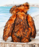Marigold standing, viewed from behind.
Marigold is a very large and beautifully coloured, one of a kind, artist bear by Barbara Ann Bears in luxurious fluffy black tipped orange faux fur and very long gold coloured mohair, she stands 24 inches/60 cm tall.