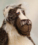 Nicholas Prickleless has beautiful hand painted slightly sparkling glass eyes (they were painted to complement his mohair) with eyelids, a wonderful nose embroidered with individual threads to match his mohair and a broad and cheerful smile