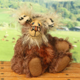 Nimble Nigel sitting and waving. Nimble Nigel is an endearingly sweet and joyful one of a kind artist bear by Barbara-Ann Bears in wonderful brown mohair, he stands just 6.5 inches/17cm